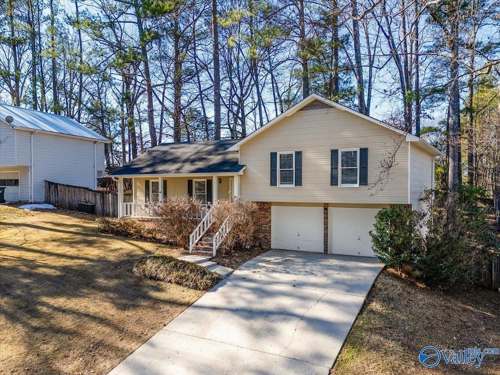 split level home with a garage and a porch