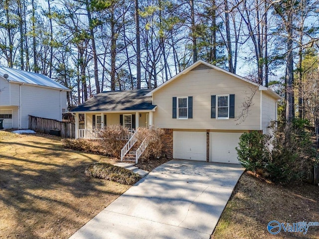 split level home with a garage and a porch