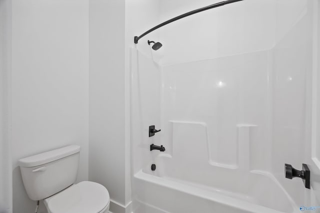 bathroom featuring shower / bathtub combination and toilet