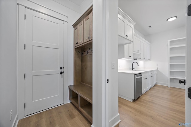 mudroom featuring sink and light hardwood / wood-style flooring