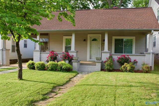 1613 Beirne Ave, Huntsville, AL 35801 - view of front of house with a porch, brick siding, a shingled roof, and a front lawn