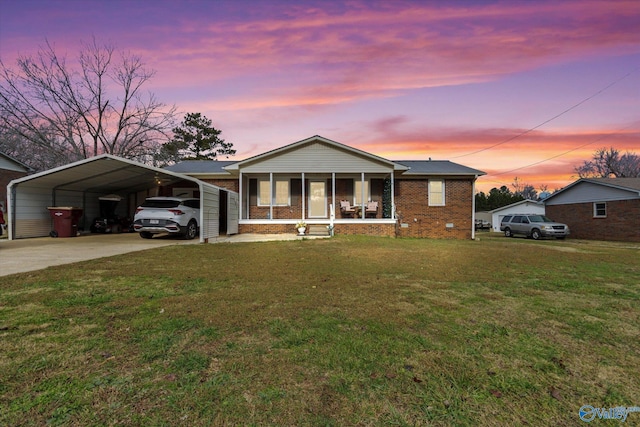 view of front of home featuring a lawn, a sunroom, and a carport