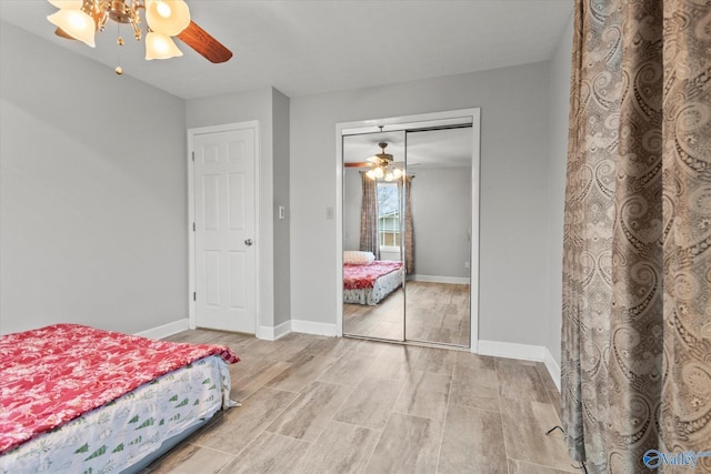 unfurnished bedroom with ceiling fan, a closet, and light wood-type flooring