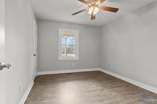 spare room featuring ceiling fan and dark wood-type flooring