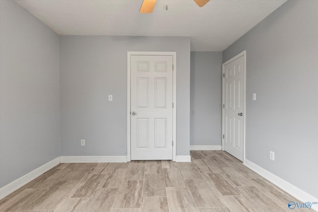 unfurnished bedroom with light wood-type flooring and ceiling fan