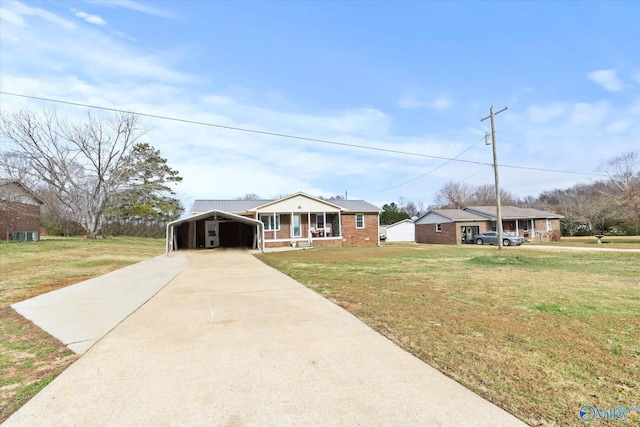 ranch-style house with covered porch, a carport, and a front yard