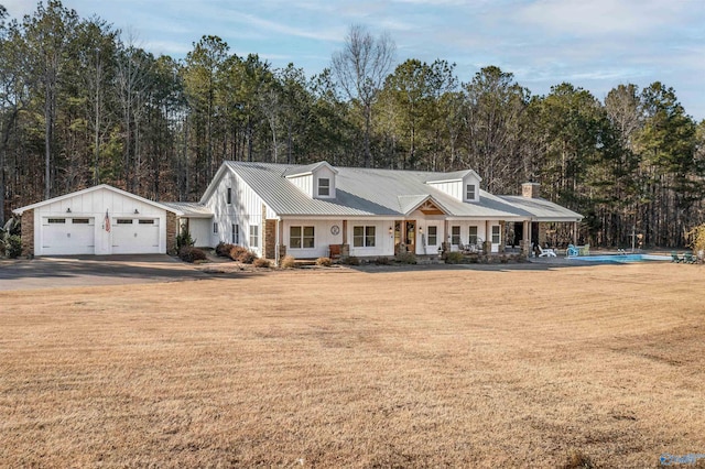 view of front of property with metal roof, a porch, and a front yard