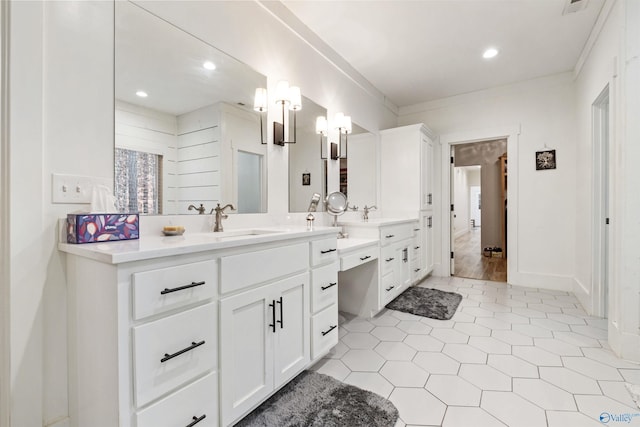 bathroom with recessed lighting, baseboards, crown molding, and vanity