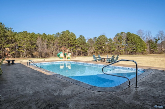 pool featuring a patio area and playground community