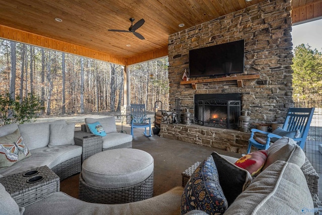 view of patio / terrace with a ceiling fan and an outdoor living space with a fireplace