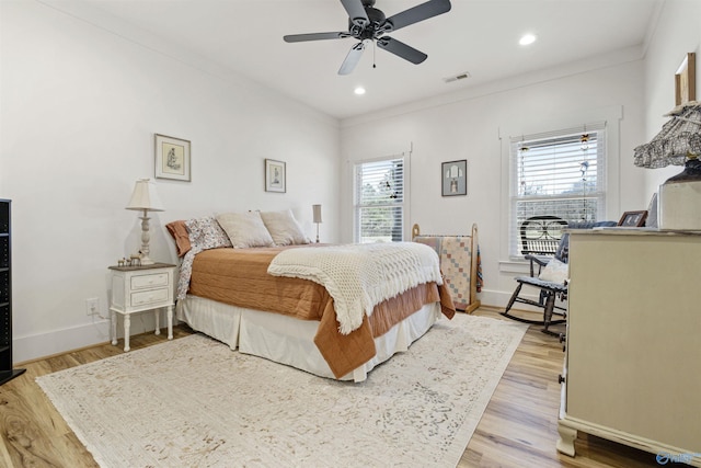 bedroom with visible vents, crown molding, and multiple windows