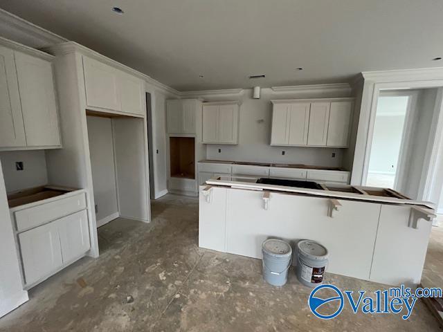 kitchen featuring white cabinetry and a breakfast bar