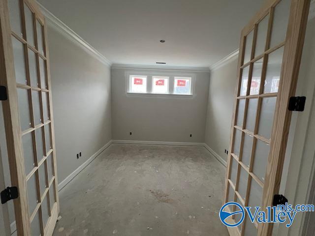 spare room featuring crown molding and french doors