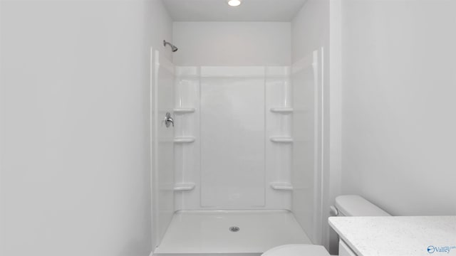 bathroom with walk in shower and toilet