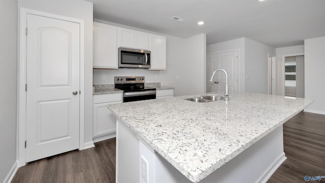 kitchen with sink, stainless steel appliances, an island with sink, and white cabinets