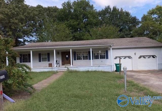 1607 Tennessee St, Sheffield, AL 35660 - single story home featuring a front lawn, a porch, a garage, and concrete driveway