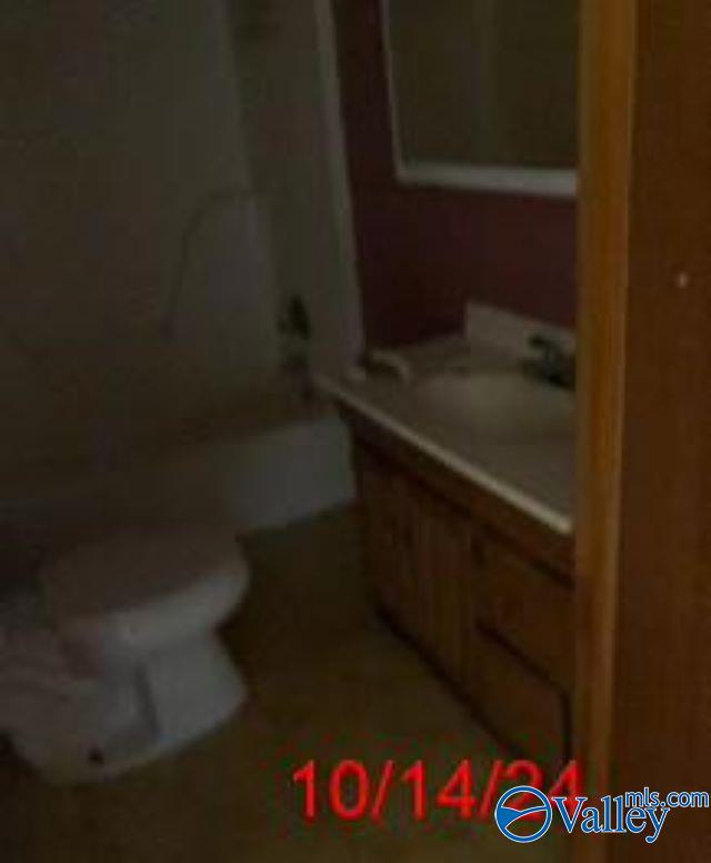 1607 Tennessee St, Sheffield, AL 35660 - bathroom with toilet, vanity, and a shower