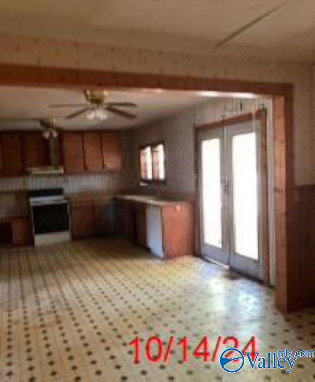 1607 Tennessee St, Sheffield, AL 35660 - kitchen with ceiling fan, range with electric stovetop, and brown cabinets