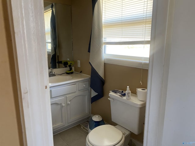 bathroom featuring toilet, tile patterned floors, and vanity