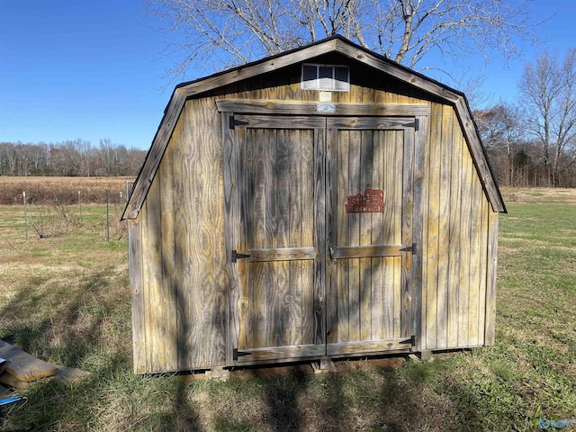 view of outbuilding featuring a lawn