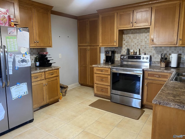 kitchen with decorative backsplash, light tile patterned floors, and stainless steel appliances