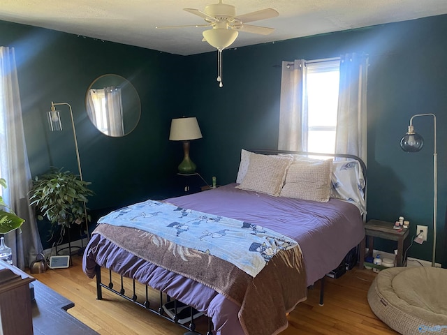 bedroom featuring ceiling fan and hardwood / wood-style floors