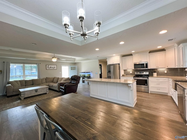 1575 Cottage Ln, Southside, AL 35907 - kitchen with appliances with stainless steel finishes, crown molding, open floor plan, light stone countertops, and white cabinets