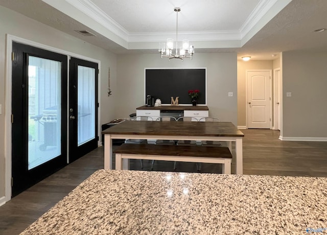 1575 Cottage Ln, Southside, AL 35907 - dining area with dark wood-type flooring, ornamental molding, a raised ceiling, a chandelier, and baseboards