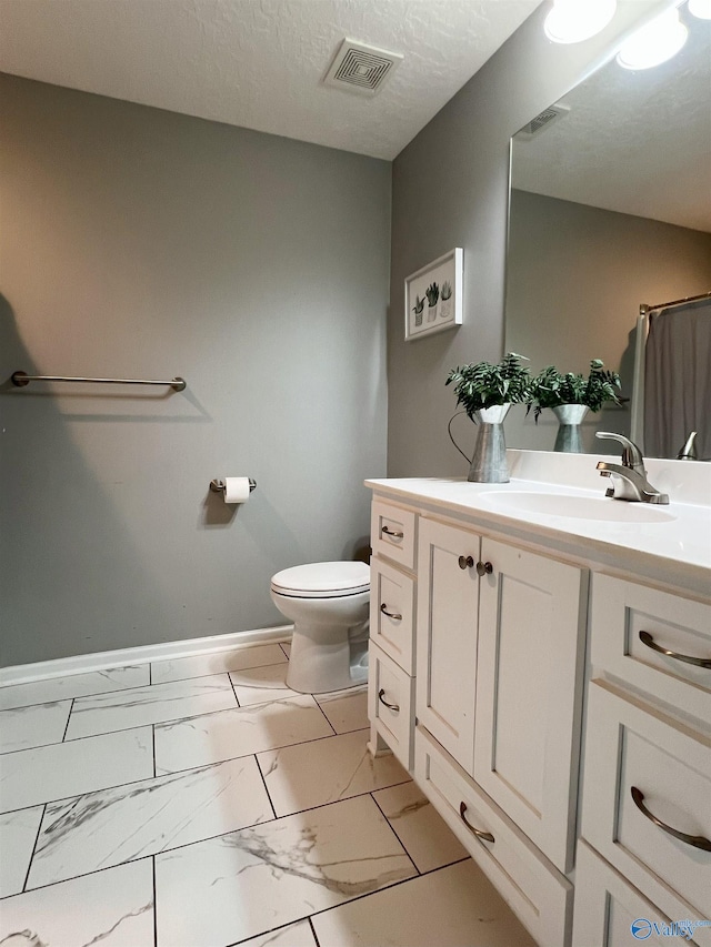 1575 Cottage Ln, Southside, AL 35907 - full bathroom with marble look tile flooring, vanity, toilet, and baseboards