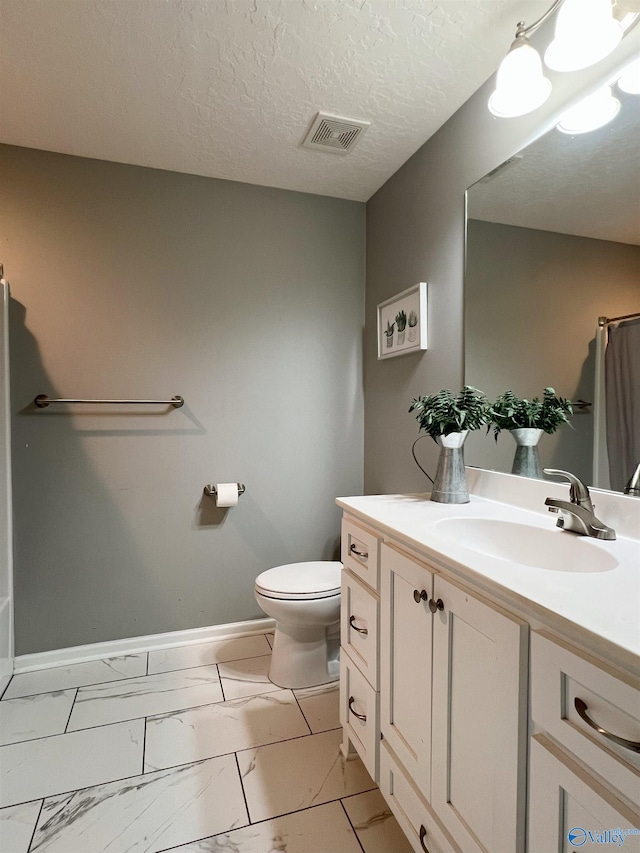 1575 Cottage Ln, Southside, AL 35907 - bathroom with marble look tiles, toilet, vanity, and baseboards