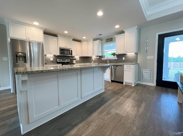 1575 Cottage Ln, Southside, AL 35907 - kitchen featuring appliances with stainless steel finishes, white cabinetry, backsplash, dark wood-style flooring, and crown molding