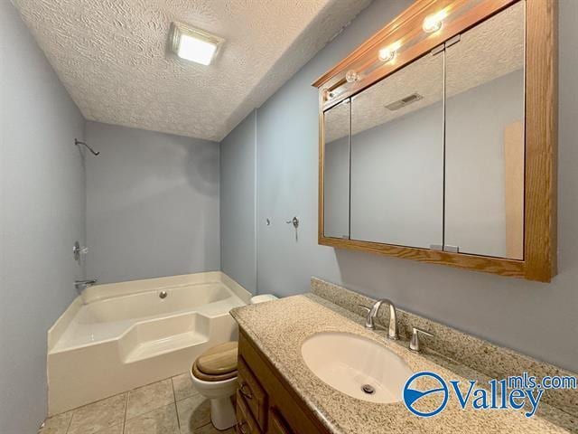 bathroom with a washtub, tile patterned flooring, vanity, a textured ceiling, and toilet