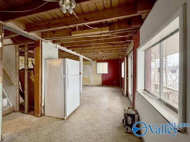 basement featuring white fridge