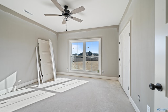 unfurnished bedroom with concrete flooring, visible vents, and baseboards