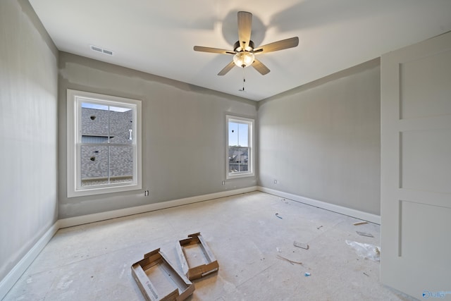 unfurnished room featuring a ceiling fan, visible vents, and baseboards