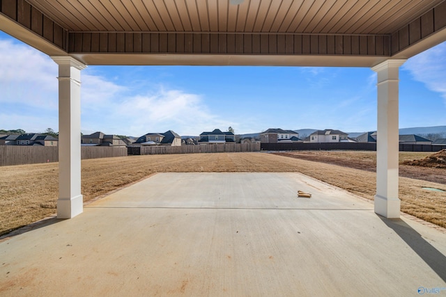 view of patio / terrace with a fenced backyard and a residential view