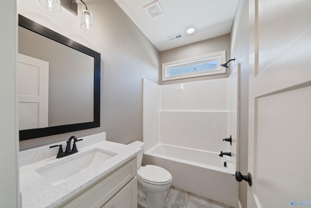 full bathroom with visible vents, vanity, toilet, and tub / shower combination