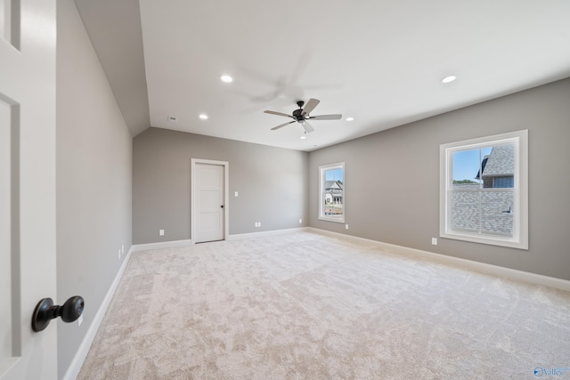 spare room with light carpet, ceiling fan, baseboards, and recessed lighting