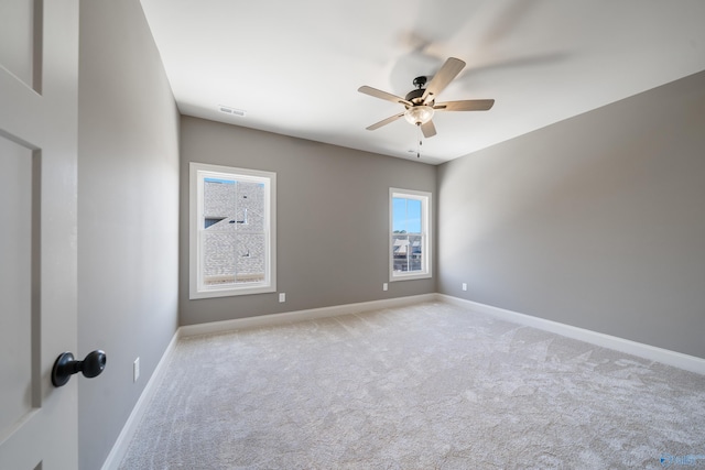 spare room featuring ceiling fan, baseboards, and carpet flooring