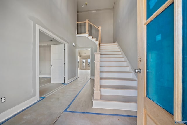 foyer entrance featuring a high ceiling and stairway