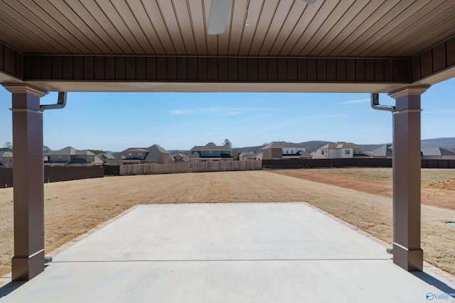 view of patio / terrace with a residential view and fence