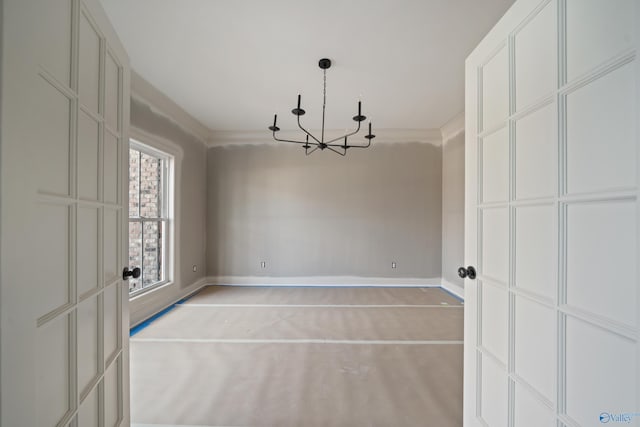 unfurnished dining area with baseboards, a chandelier, and ornamental molding