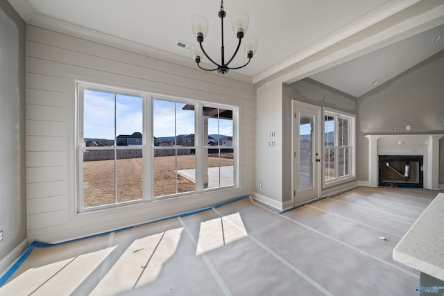 interior space featuring wooden walls, baseboards, visible vents, a glass covered fireplace, and a chandelier