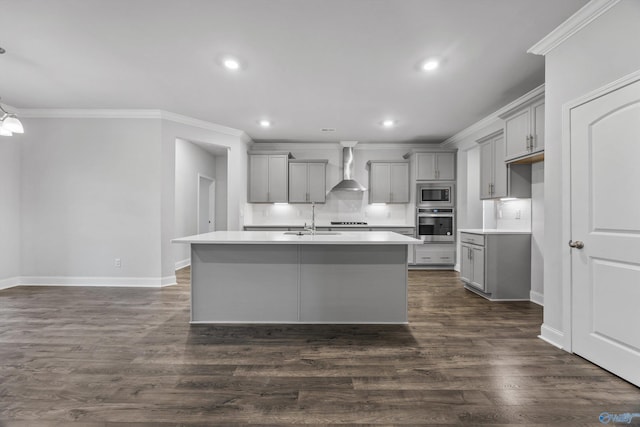 kitchen with gray cabinets, a sink, baseboards, stainless steel appliances, and wall chimney exhaust hood