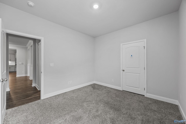 unfurnished room featuring carpet floors and baseboards