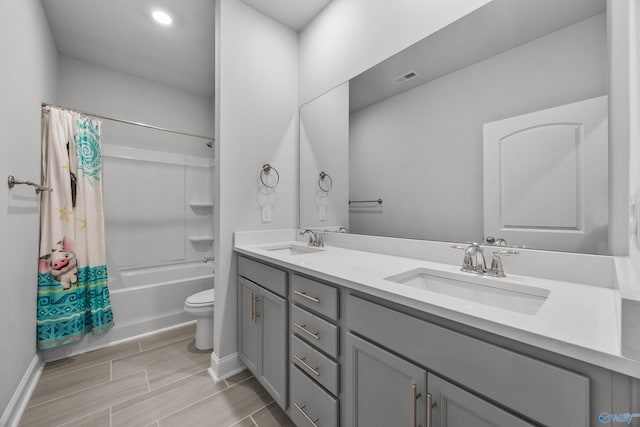 bathroom featuring a sink, baseboards, shower / bathtub combination with curtain, and double vanity