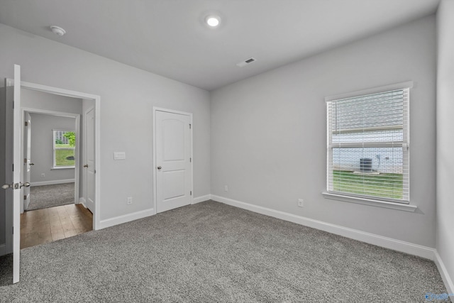 unfurnished bedroom with baseboards, carpet flooring, and visible vents