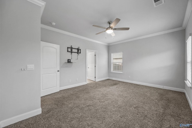 unfurnished room with crown molding, ceiling fan, visible vents, and baseboards