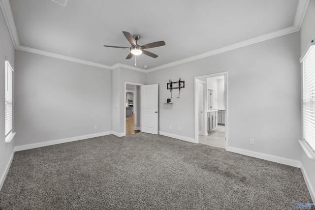unfurnished bedroom featuring baseboards, ornamental molding, and carpet