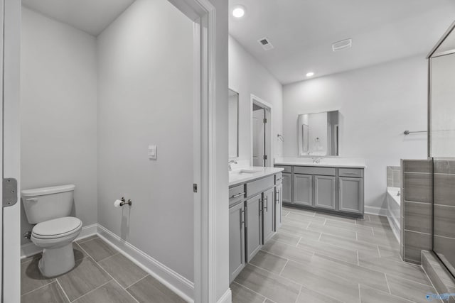 full bath featuring visible vents, a garden tub, vanity, toilet, and recessed lighting